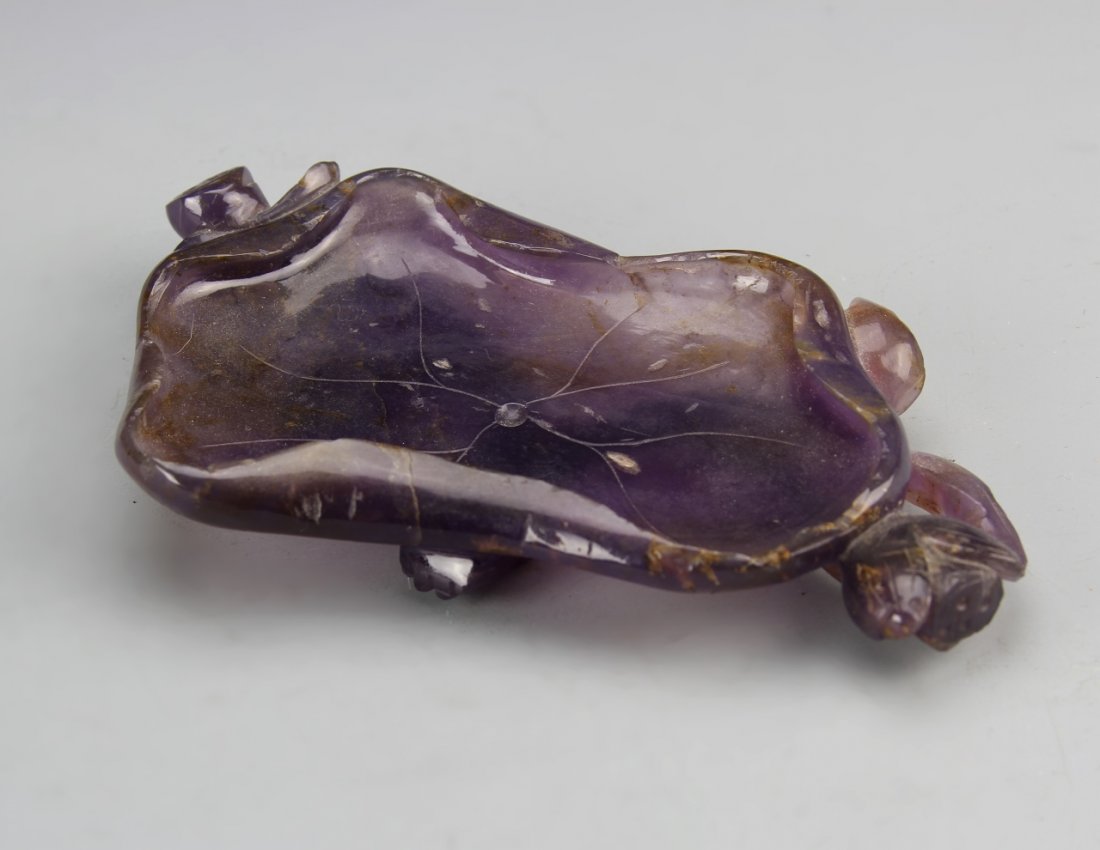 Chinese Amethyst Brush Washer: China, amethyst brush washer, in organic form, with carved floral motifs, in a deep purple hue, with striations in the stone and high shine surface. Height 3 in., Width 5 1/2 in.