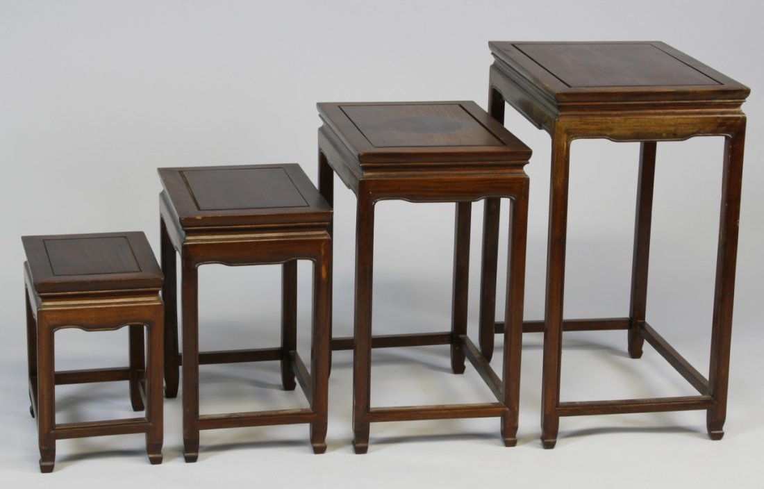 Chinese Huanghuali Nesting Tables: China, Early 20th C., Huanghuali nesting tables, set of four, with stretchers and a geometric apron, and natural wood grain showing. Height 26 in., Width 20 in., Length 14 in.
