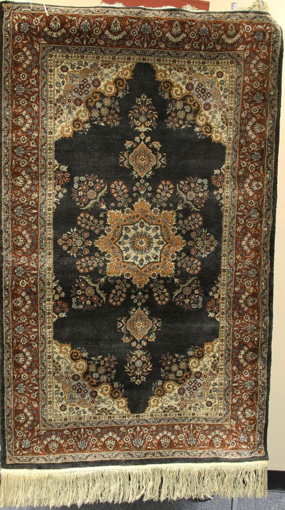 Antique Chinese Silk Carpet: China, rectangular in form, silk carpet with a dense floral pattern and three central medallion designs, cream fringe on ends. Width 36 in., Length 60 in.