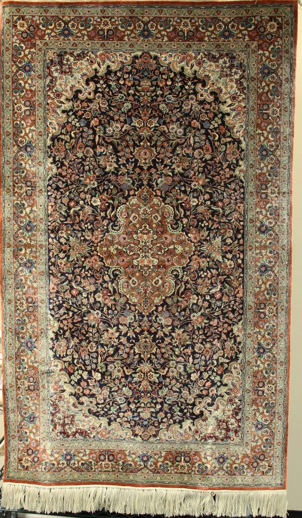 Antique Chinese Silk Carpet: China, rectangular in form, silk carpet with a dense floral pattern and a center medallion design, cream fringe at the ends. Width 36 in., Length 60 in.