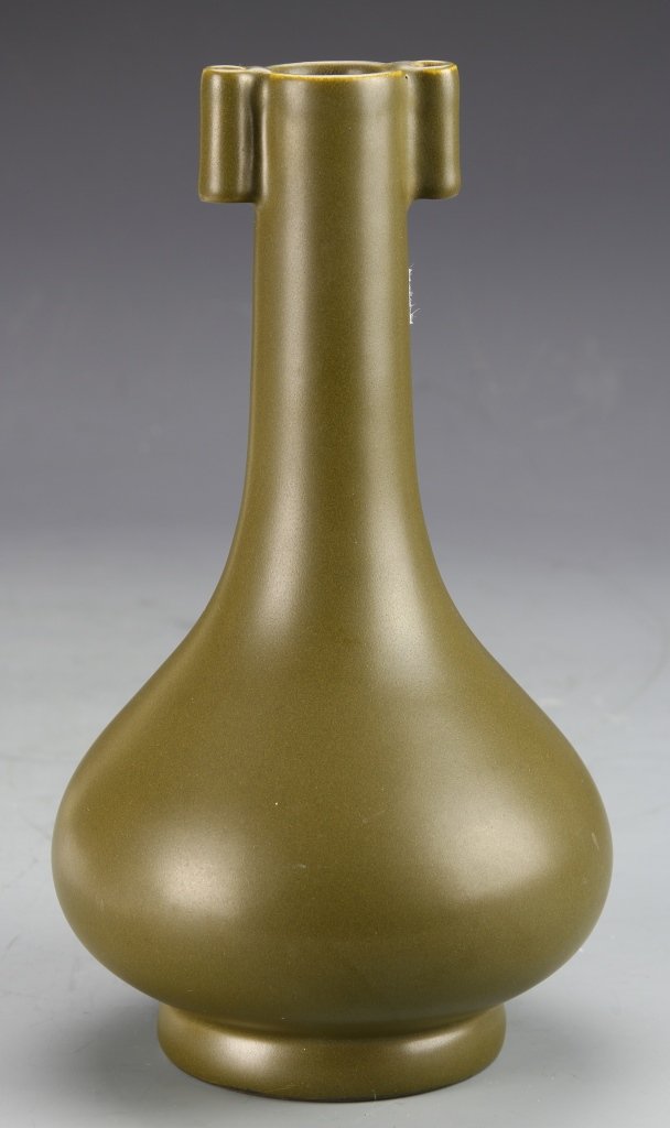 Chinese Tea Dust Vase: China, tea dust-glazed vase in a long neck form with bulbous body on footed base, two oblong ears at the small rim, in an mottled olive green color, Qianlong mark on base. Height 9 1/2 in.