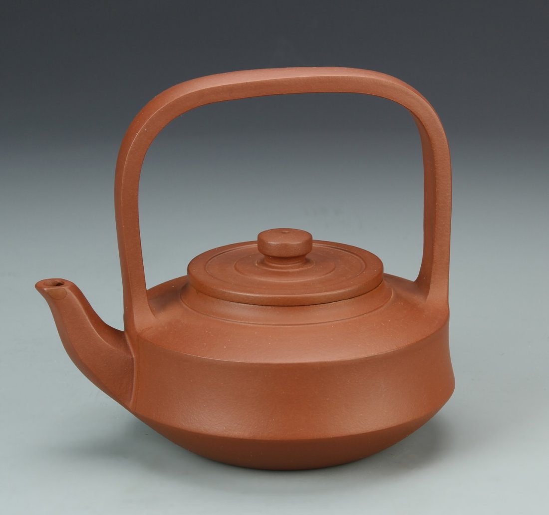 Chinese Yixing Zisha Tea Pot: China, Yixing Zisha tea pot, simple and clean design with large arcing handle, with mark on base, and certificate. Width 6 1/4 in., Height 6 1/2 in.