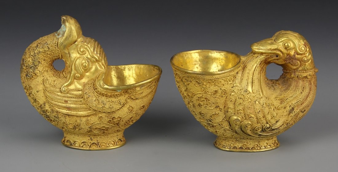 Chinese Pair of Gilt Wine Cups: China, pair of gilt wine cups in the form of birds with delicate gold decoration, some patina present. Height 2 1/2 in.
