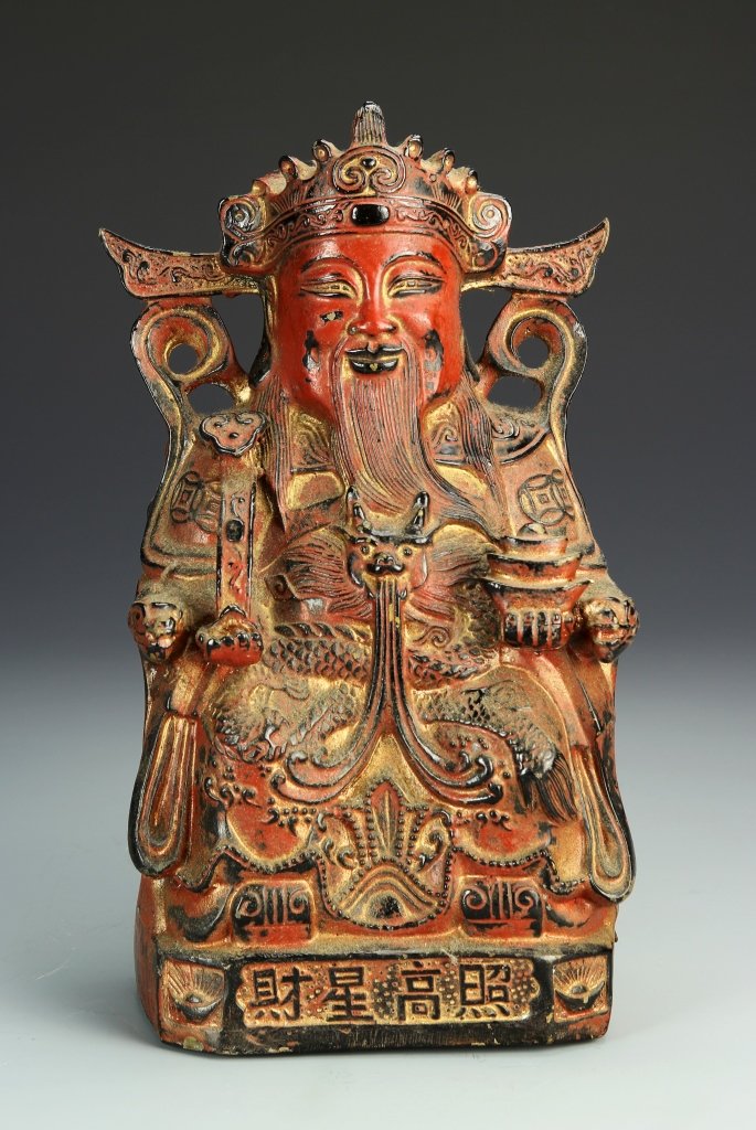 Chinese Copper God of Wealth: China, copper god of wealth figure, seated on his throne and set on a square, decorated base showing symbols of prosperity, carved and edged in black to highlight tiny details of his robe, face, the b