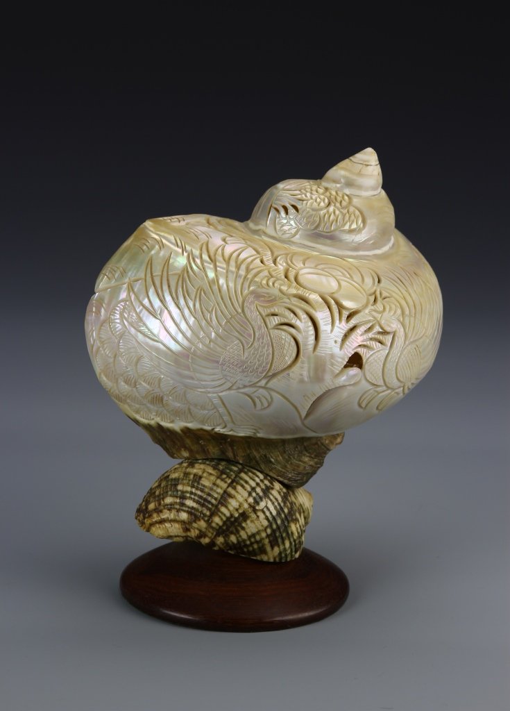 Chinese Carved Shell Converted Lamp: China, carved shell converted lamp, large spiraling shell carved with floral detail, resting on a smaller shell. Height 7 1/2 in.