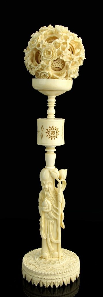 Chinese Carved Ivory Ball on Stand: China, 19th C., intricately carved ivory ball, with articulated inner balls that rotate, with a carved Luohan figural stand. Height 12 in.