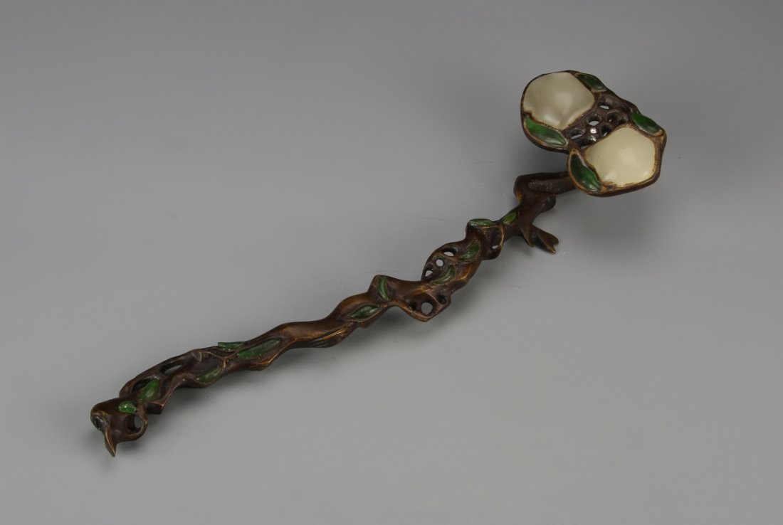 Chinese Jade and Bronze Ruyi Scepter: China, jade and bronze ruyi scepter, staff carved in organic form with decorative green leaves, head of scepter split into two large jade pieces. Length 10 7/8 in.