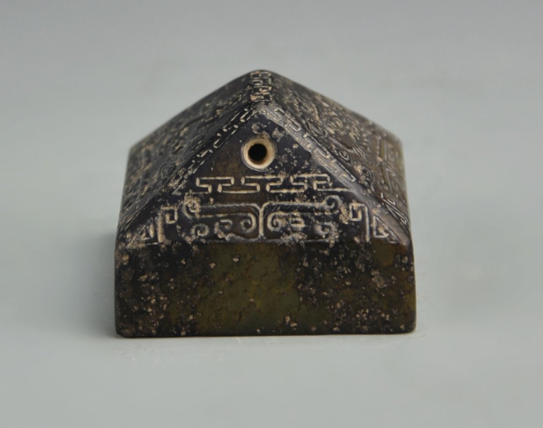 Chinese Antique Jade Seal Chop: China, antique jade seal chop of blackish hue, four sides rising straight up and then slanting inwards to a peak, carved with patterned bands, small opening at top. Height 2 in., Width 2 5/8 in., Leng