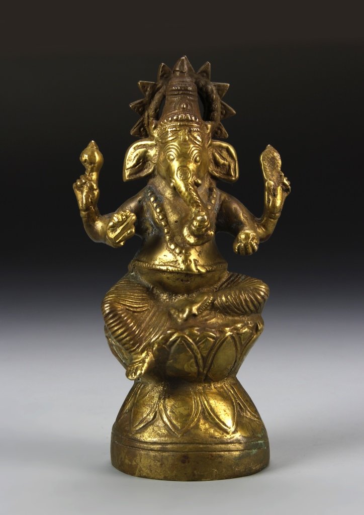 Tibetan Antique Bronze Buddha: Tibet, antique bronze Buddha figure, in a seated position, with elephant head, both arms raised, and intricate linear designs. Height 7 in.