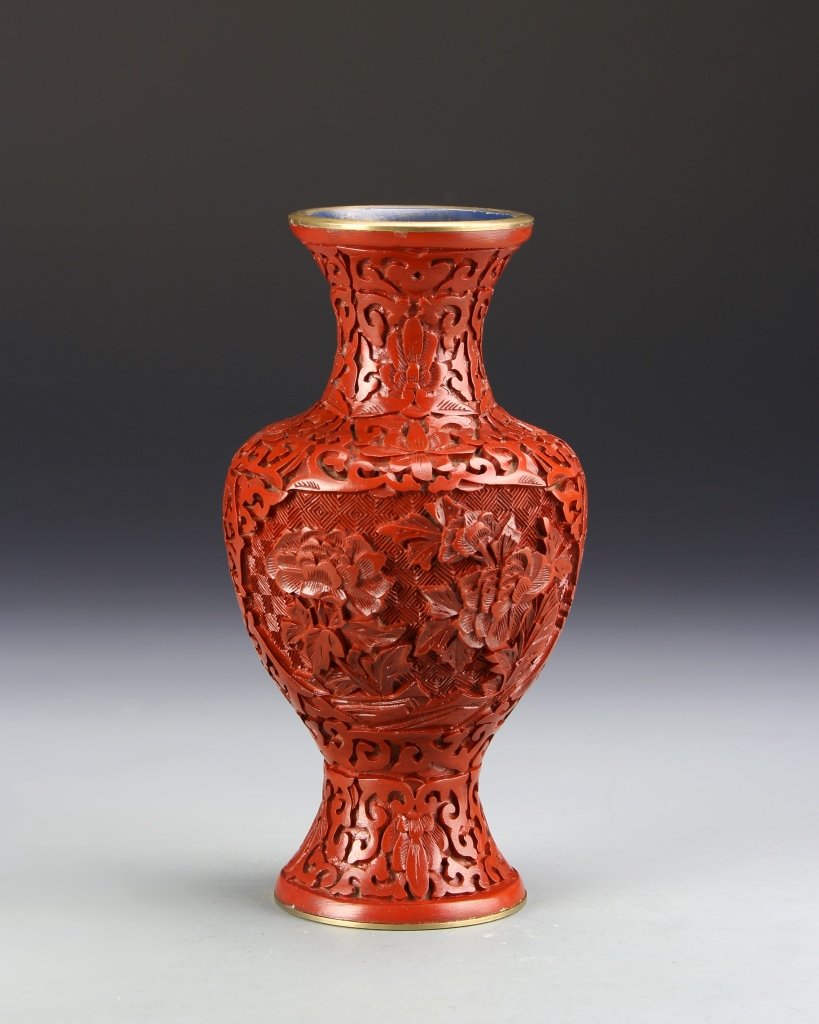 Chinese Cinnabar Vase: China, ROC Period, cinnabar vase, rounded shoulders with flaring foot and rim, featuring a central panel of flowers and floral motifs. Height 7 in.