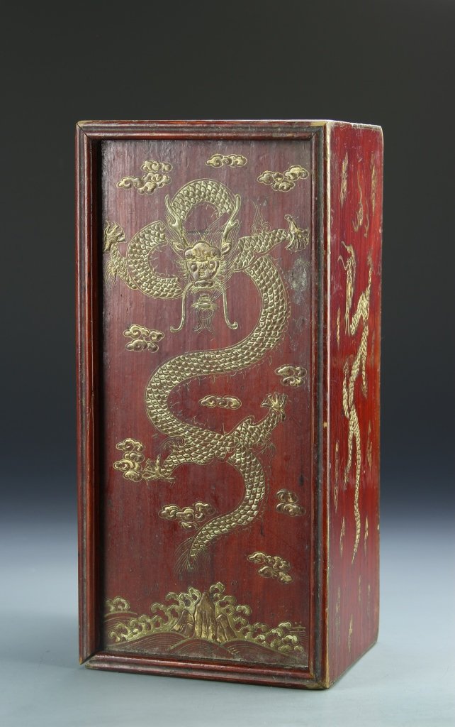 Chinese Wooden Jewelry Box: China, 19th C., wood jewelry box, red painted box with gilt dragons on the sides, cover decorated with a dragon over a mountain and seascape. Height 5 3/4 in., Width 11 3/4 in.