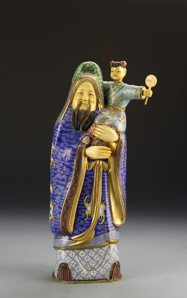 Chinese Cloisonne Figure: China, cloisonne figure, in a standing position, wearing a elaborately paint robe, holding a small child on his shoulder. Height 13 1/2 in.