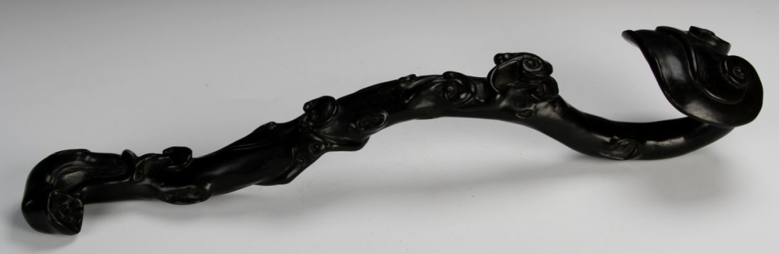 Chinese Zitan Ruyi Scepter: China, 19th C., expertly carved Zitan ruyi scepter, with natural motifs and vines accenting the sides, and natural wood grain showing. Length 16 1/4 in.