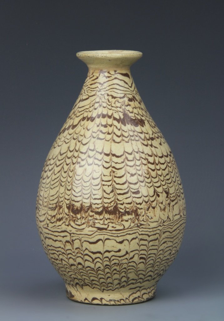 Chinese Antique Tang Style Vase: China, antique Tang style vase, with bulbous body, narrow neck, flared rim and footed base, the brown glaze applied in a pattern of rows each peaked with points pulled through the glaze. Height 6 1/4