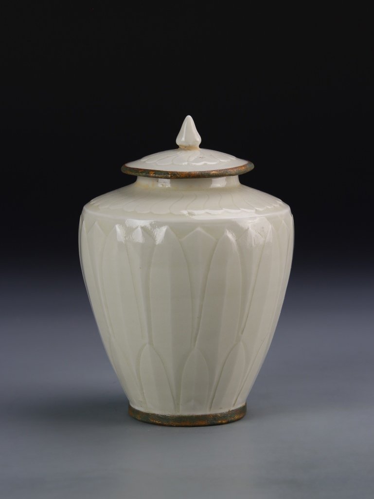 Chinese Ding Ware Jar: China, antique Ding ware jar, with cover, high shoulder, in a white hue, with pedal motifs across the body, and high shine surface. Height 5 3/4 in.