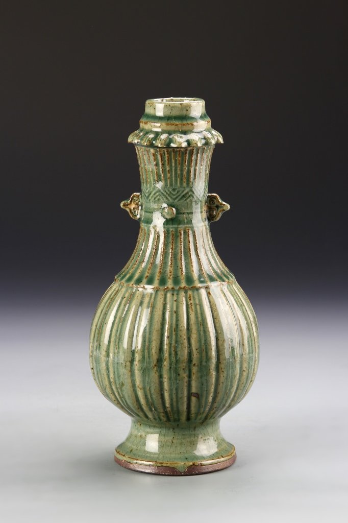 Chinese Green Glazed Vase: China, Yuan Dynasty, green glazed vase, flared base, with bulbous, long narrow neck, textured surface, small attached ears, high shine surface. Height 9 1/4 in.
