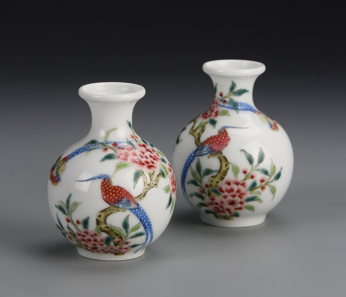 Pair of Chinese Enameled Water Coups: China, ROC Period, a pair of enameled water coups, in bulbous form with flared neck, and colorful flower and bird motifs against white background. Height 2 7/8 in.
