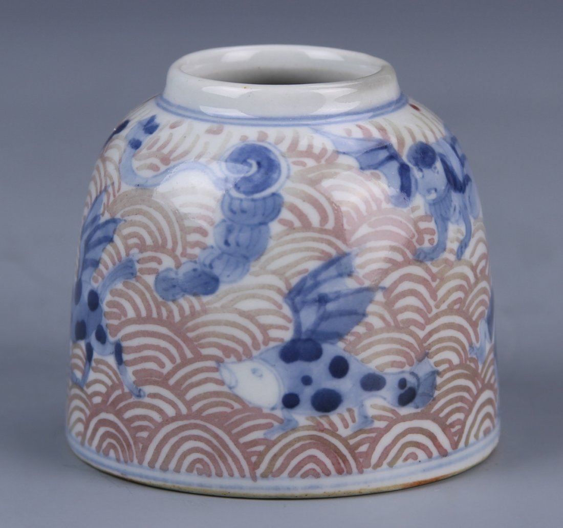 Chinese Blue and White Water Coup: China, 18th C., Kangxi period blue and white copper-red water coup, short and round in form, decorated with flying mythical creatures, red ground with blue paint, double ring mark. Height 2 1/4 in.