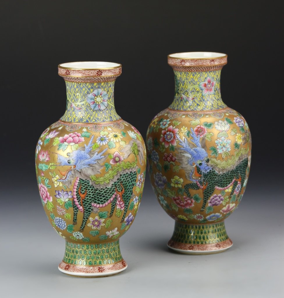 Pair of Chinese Famille Rose Vases: China, a pair of Famille Rose vases, with high shoulder and tapered neck, on a platform base, and floral and dragon motifs, Qianlong Mark. Height 7 in.