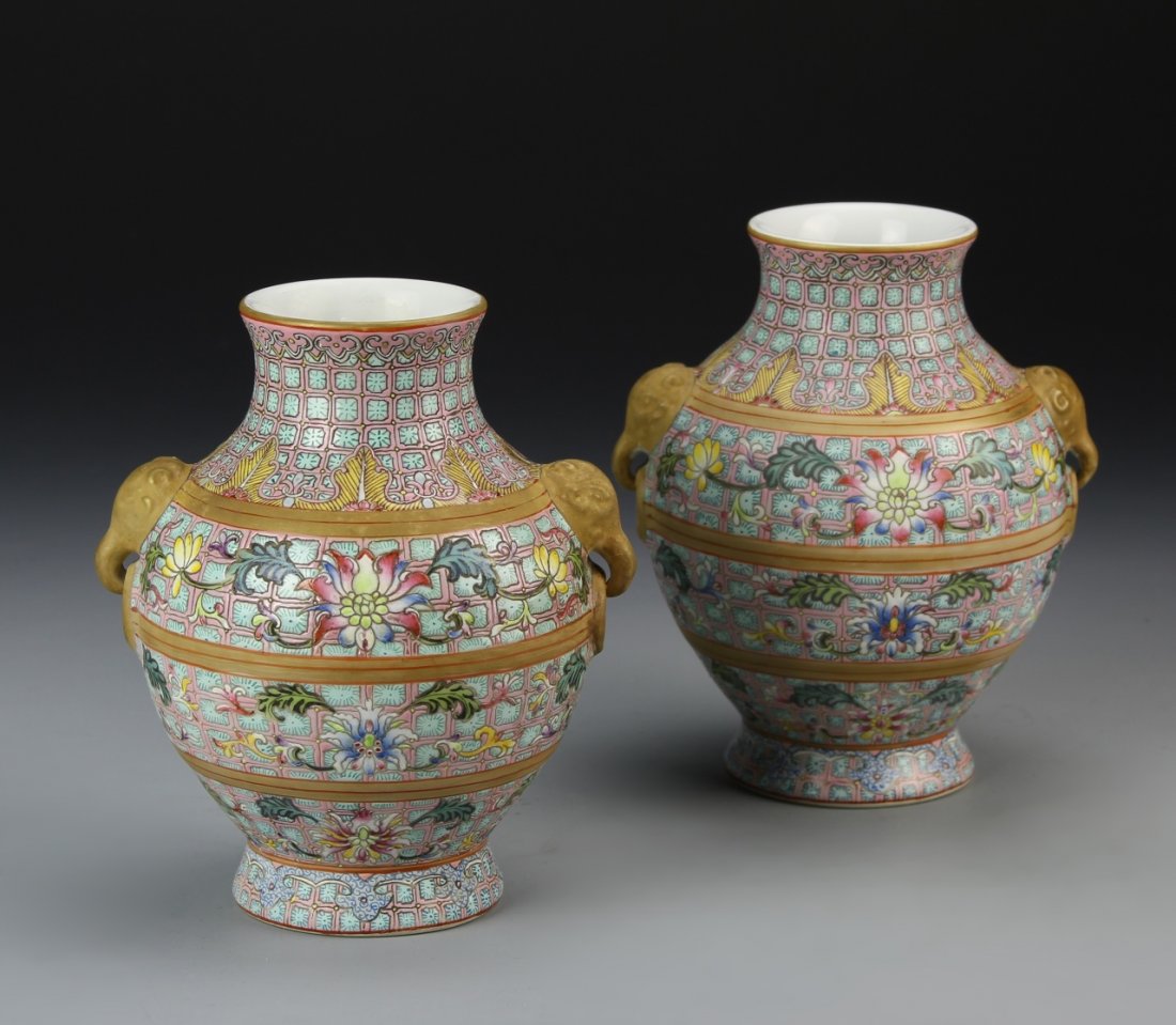 Pair of Chinese Famille Rose Vases: China, a pair of Famille Rose vases, with a high shoulder tapering to the rim, two elephant head decorative handles, and scrolling floral motifs, Yongzhen mark. Height 5 1/2 in.