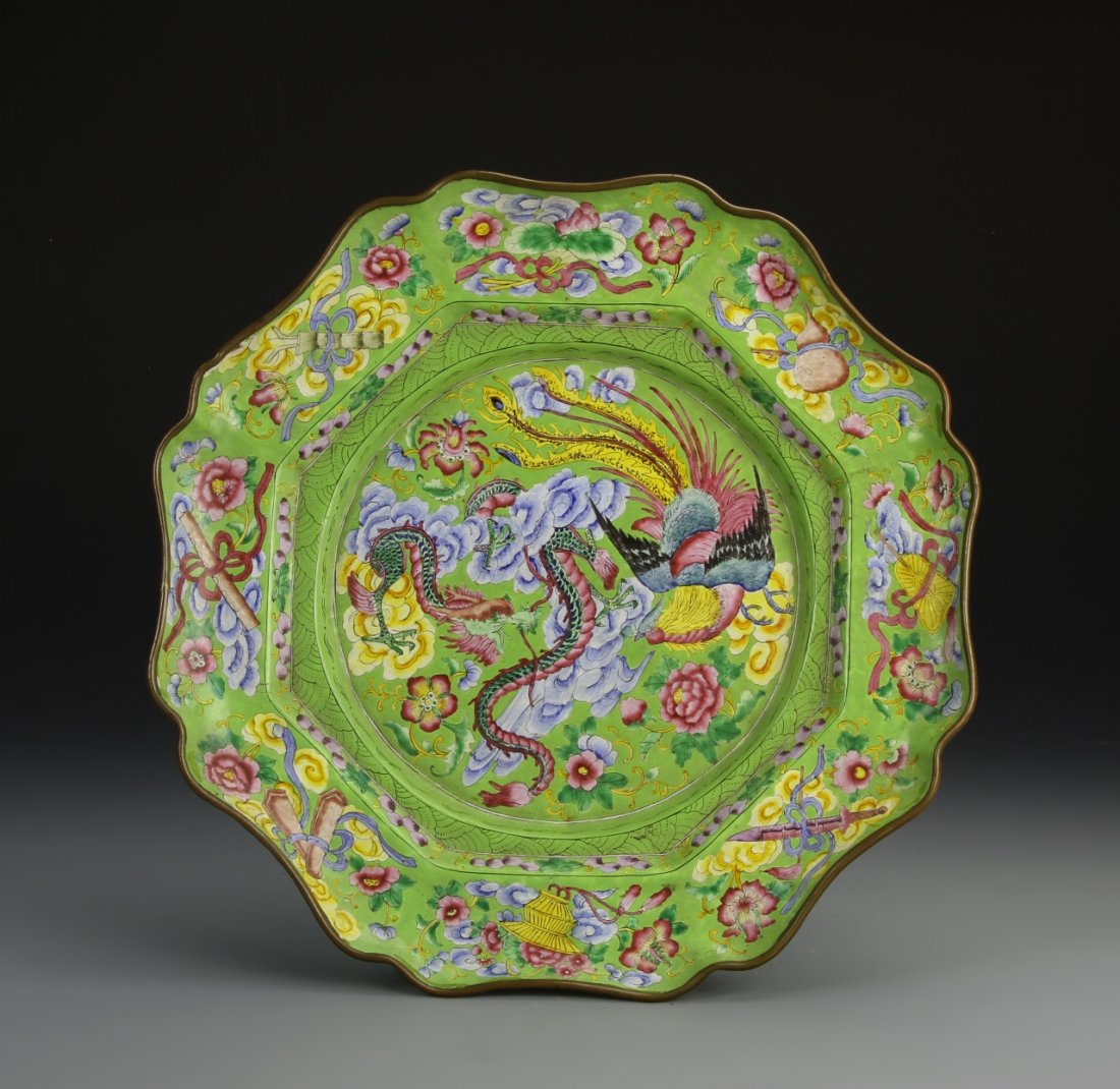Chinese Enameled Plate: China, 19th C., enameled plate, scalloped rim, green ground with brightly painted dragon and phoenix at center, floral motif throughout, objects depicted tied in a pink ribbon decorate the rim. Diamet