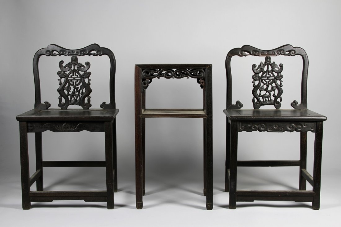Chinese Hardwood Chairs and Table: China, 19th C., a pair of hardwood chairs and a square table, all carved with traditional auspicious openwork pattern. Chairs: Height 35 5/8 in., Width 20 1/2 in., Depth 20 1/2 in. Table: Height 30 3/