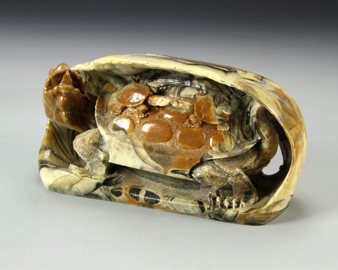 Chinese Stone Carved Turtle: China, stone carved turtle, delicately carved in high relief out of a smooth boulder, the animal with large shell and turned head, with smaller turtles on its back, great detail seen in the shell and 