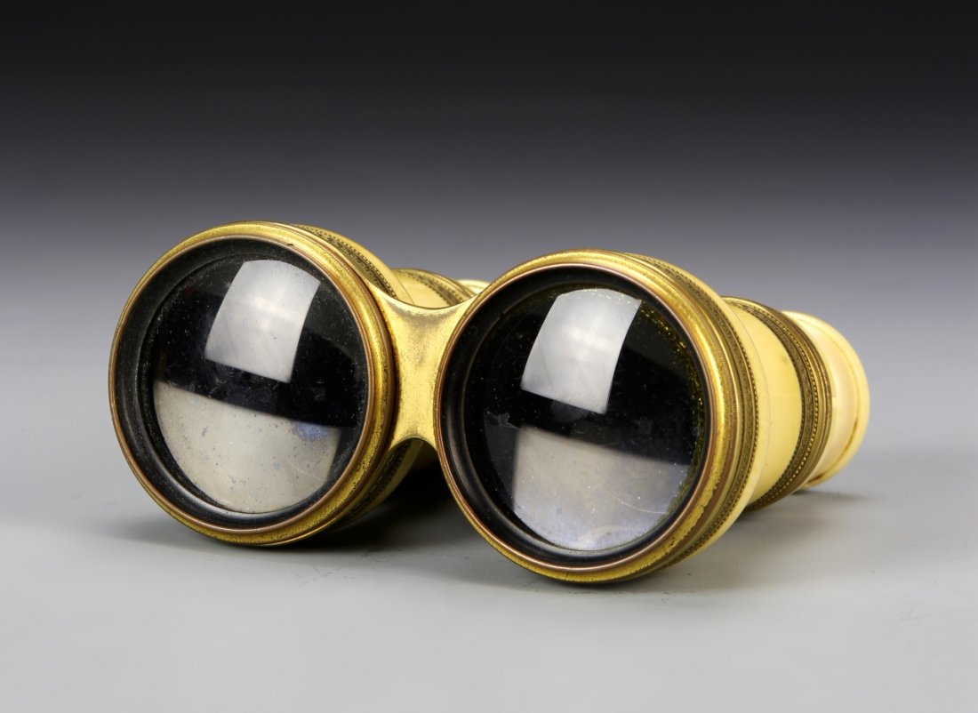 English Antique Telescope: England, antique telescope with ivory, detailed metal work, a carved ivory piece, and in a bulbous form. Height 3 3/4 in.