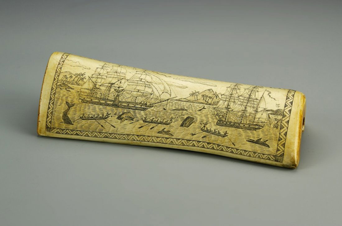 European Carved Bone Sculpture: Europe, carved bone sculpture, image of whaling ships in action on one side, opposite side reads "The Whaler Indian off Tahiti". Length 8 in.