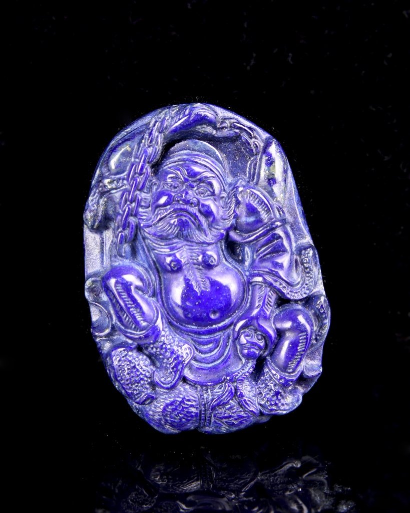 Chinese Lapis Pendant: China, ROC Period, lapis pendant, in ovular form, with detailed carvings of a figure, in a bright, deep blue hue. Length 2 1/4 in.