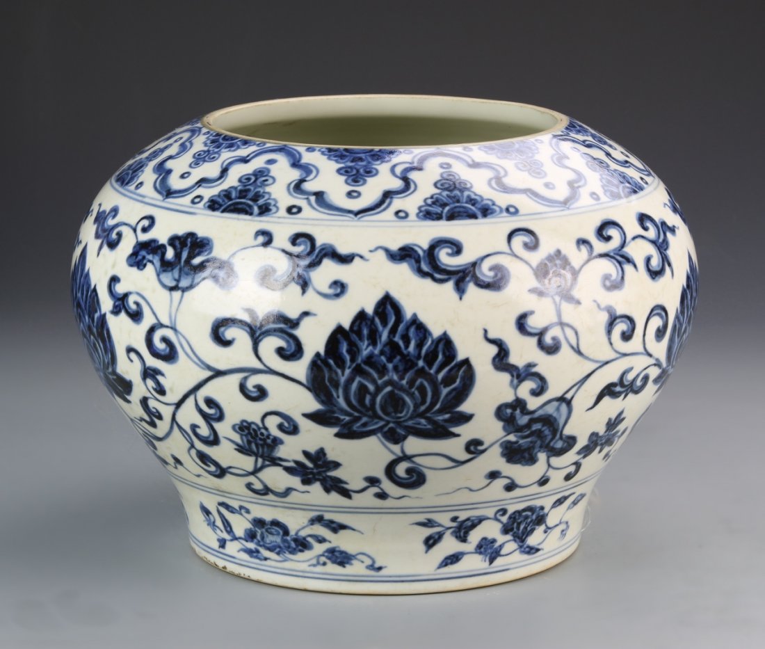 Chinese Blue and White Jar: China, Ming Dynasty, Blue and White jar, altered., rounded vessel body with footed base, large lotus blossom surrounded by scrolling vines and auspicious symbols, floral motif at base. Height 11 in., 