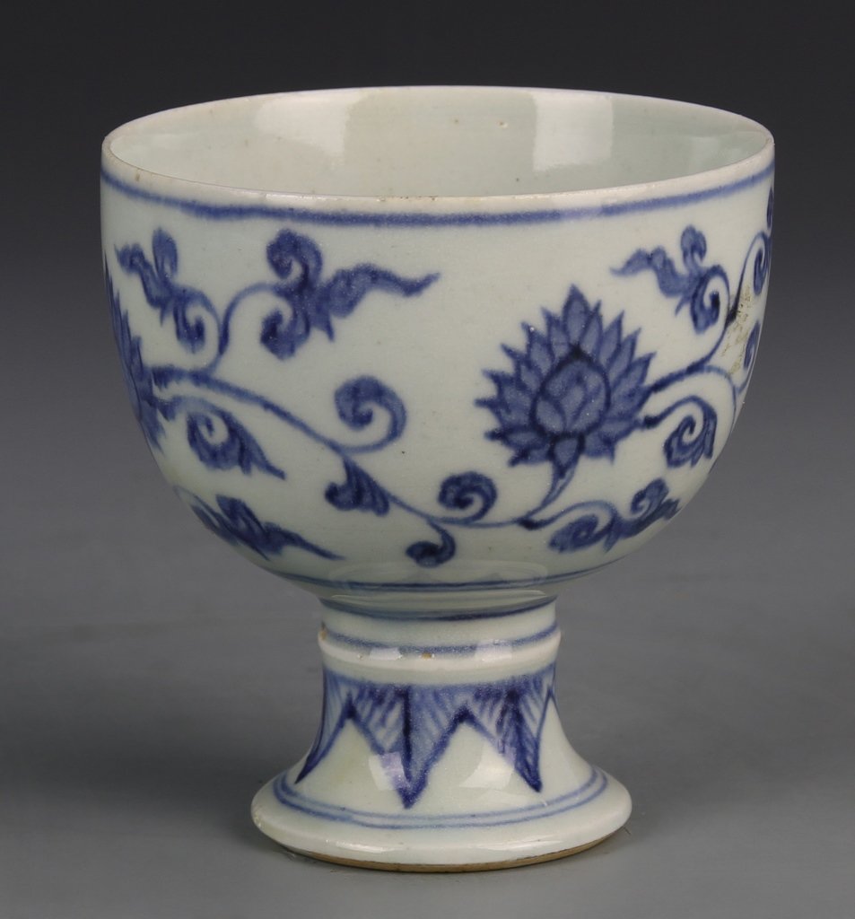 Chinese Blue and White High Stem Cup: China, Qing Period, blue and white high stem cup, flouted base, short narrow stem, wide body, scrolling floral motif decorates the body, a thick blue line borders the rim, auspicious scrolling design 