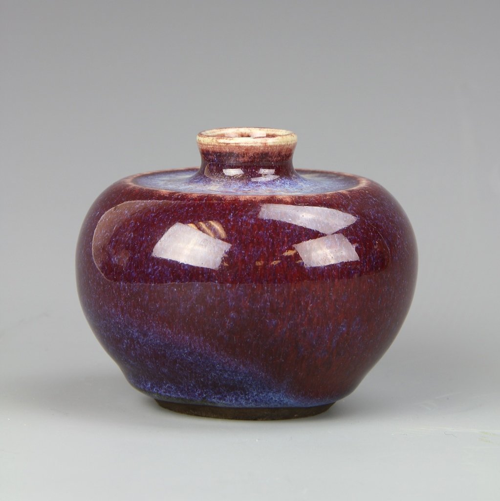 Chinese Antique Jun Ware Water Pot: China, antique Jun ware water pot, with a high shoulder, tapered rim, in a deep red hue, with a high shine, smooth surface. Height 3 in.