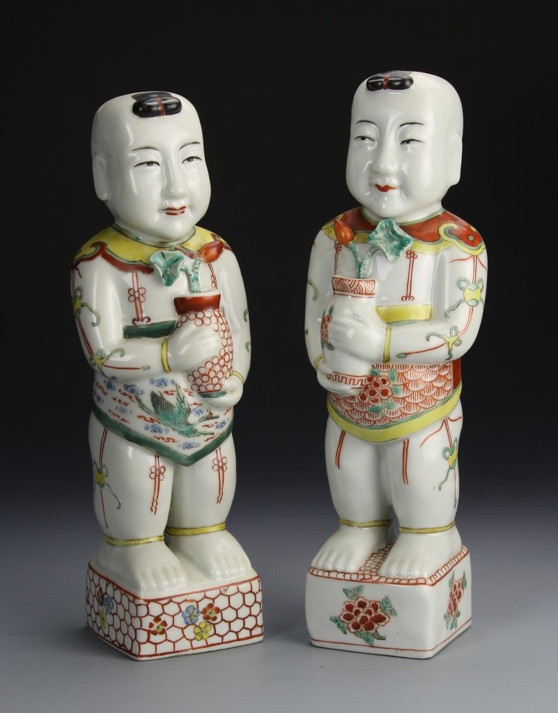 Pair of Chinese Wucai Boys: China, 18th C., pair of Wucai boys, with detailed colorful glaze depicting two boys holding vases of flowers, with a square raised pedestals. Height 11 3/4 in.