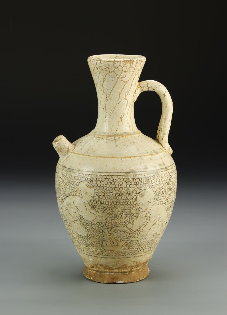 Chinese Cizhou Ware Wine Pot: China, Song Dynasty, Cizhou ware wine pot, small pouring spout on the shoulder, white glaze ground with images of children around the body. Height 10 1/4 in.