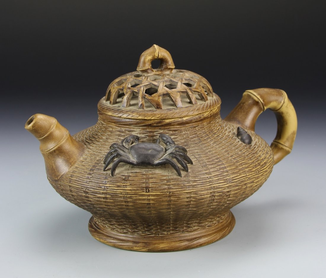 Chinese Yixing Teapot: China, Yixing teapot, with mark on base, depicted with a natural basket-weave texture along the body, natural bamboo design for the spout and handle, darker-colored figures of a crab and seashell on s