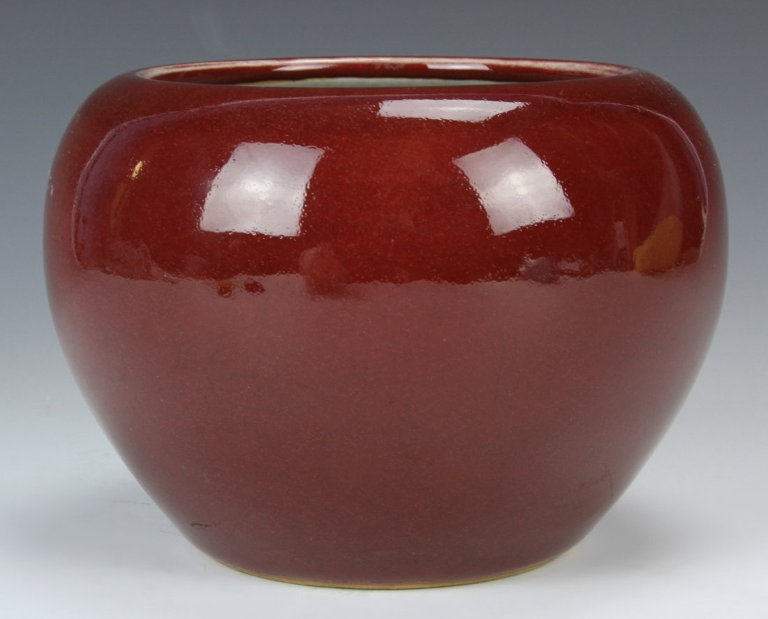 Chinese Oxblood Brush Washer: China, 19th C., oxblood red glazed brush washer, with a high shoulder tapering to a flat baser, and a crackle finish on the interior. Height 4 1/4 in., Width 6 in.