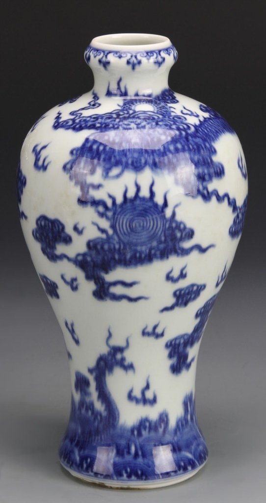 Chinese Blue and White Vase: China, 19th C., blue and white vase painted with a dragon chasing a fire ball amidst clouds, Qianlong mark on the base. Height 8 1/4 in.