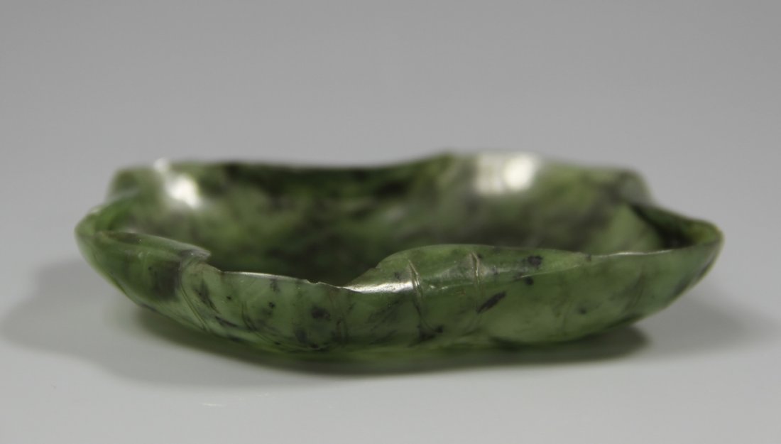 +Chinese Jade Brush Washer: China, jade brush washer, in organic form, with scalloped edges, in a deep green hue, with striations in the stone. Height 3 in., Width 3 5/8 in.