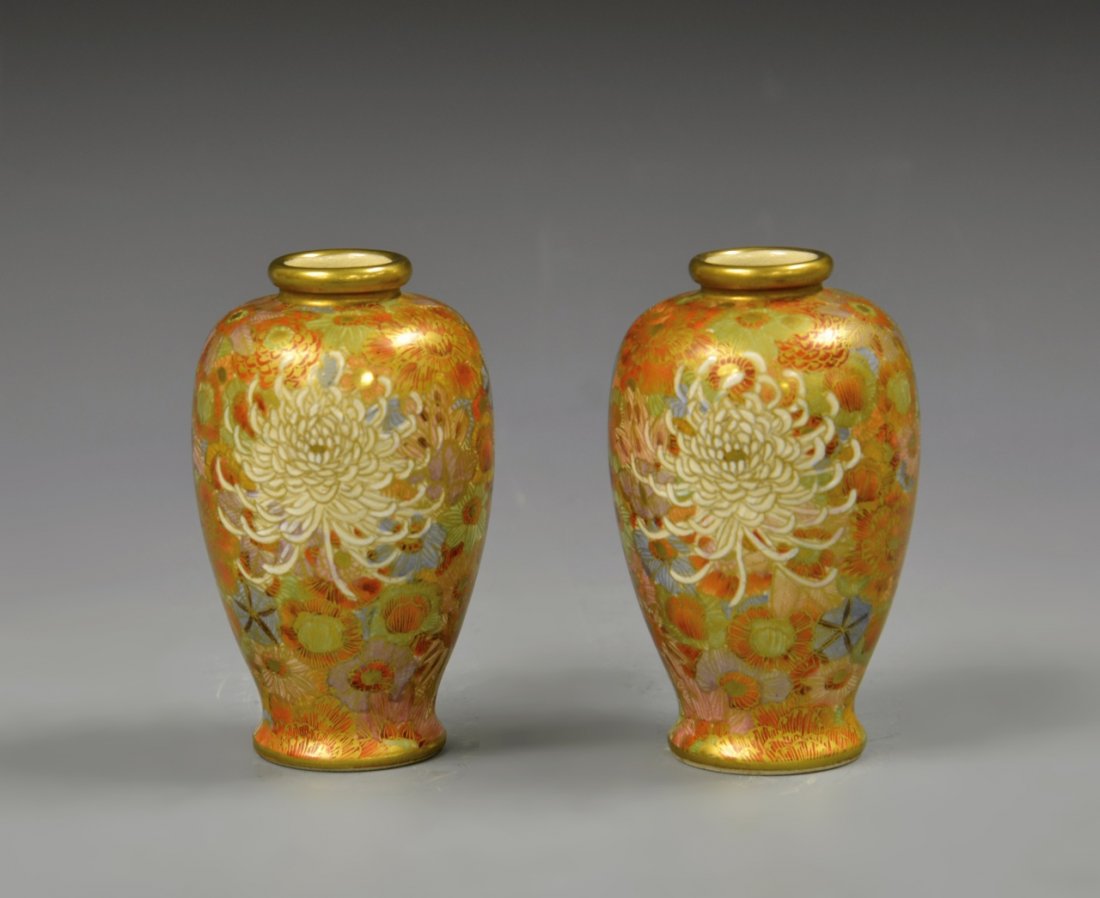 Pair of Japanese Famille Rose Vases: Japan, a pair of Famille Rose vases, with a high shoulder tapering to the rim, a fluted base, and detailed floral motifs in orange and red hues. Height 5 in.