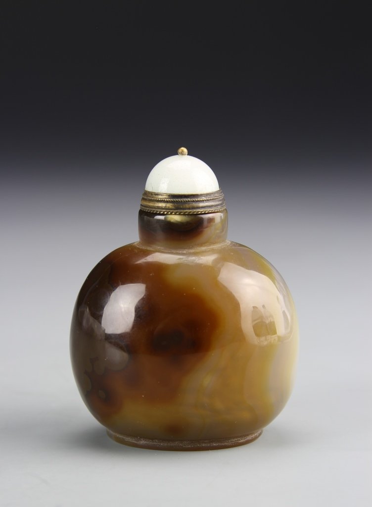 Chinese Agate Snuff Bottle: China, ROC Period, agate snuff bottle, in a rounded form, with a high shine, smoothly carved surface, in a deep brown mottled hue. Height 3/4 in.