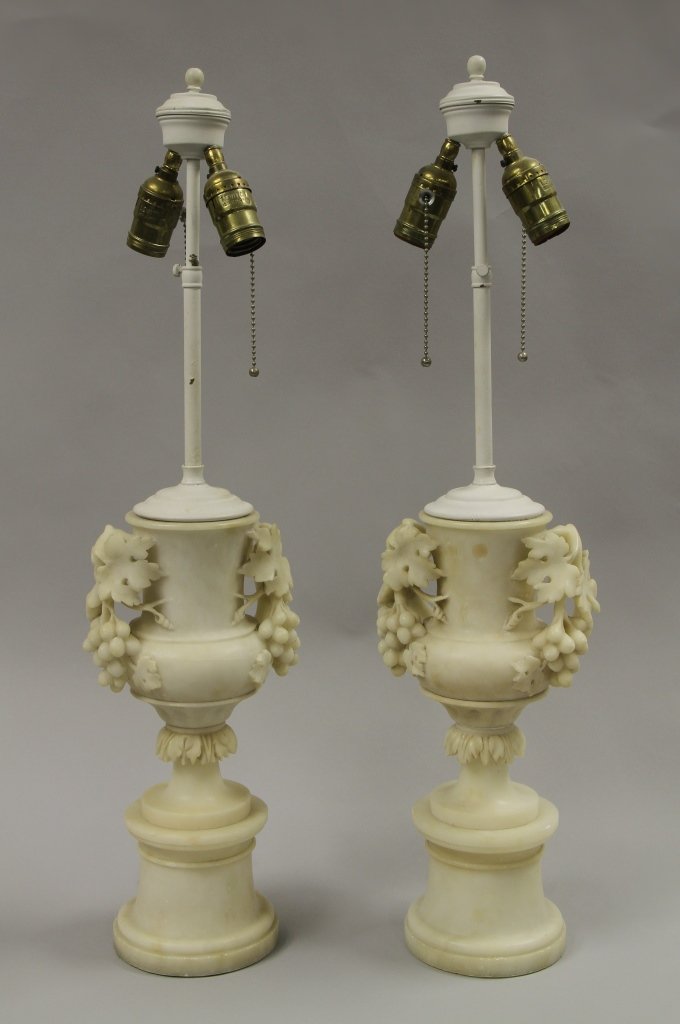 Pair of American Alabaster Carved Vases: America, a pair of alabaster carved lamps in the forms of classical vases with a vine of grapes and leaves acting as handles. Height 14 in.