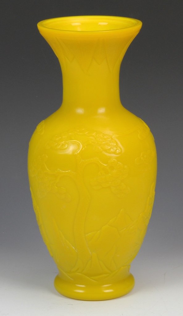 Chinese Peking Glass Vase: China, 19th C., yellow Peking glass vase, with a flared rim and footed base, molded with images of wise men figures, sitting in a clouded landscape. Height 10 3/4 in., Width 4 3/4 in.