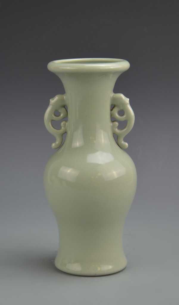 Chinese Celadon Vase: China, 19th C., celadon vase, in a baluster form, with broad shoulders, elongated neck and lipped rim, all tapering down to a narrow base, with ornate organic ears and Yongzheng mark on base. Height 9