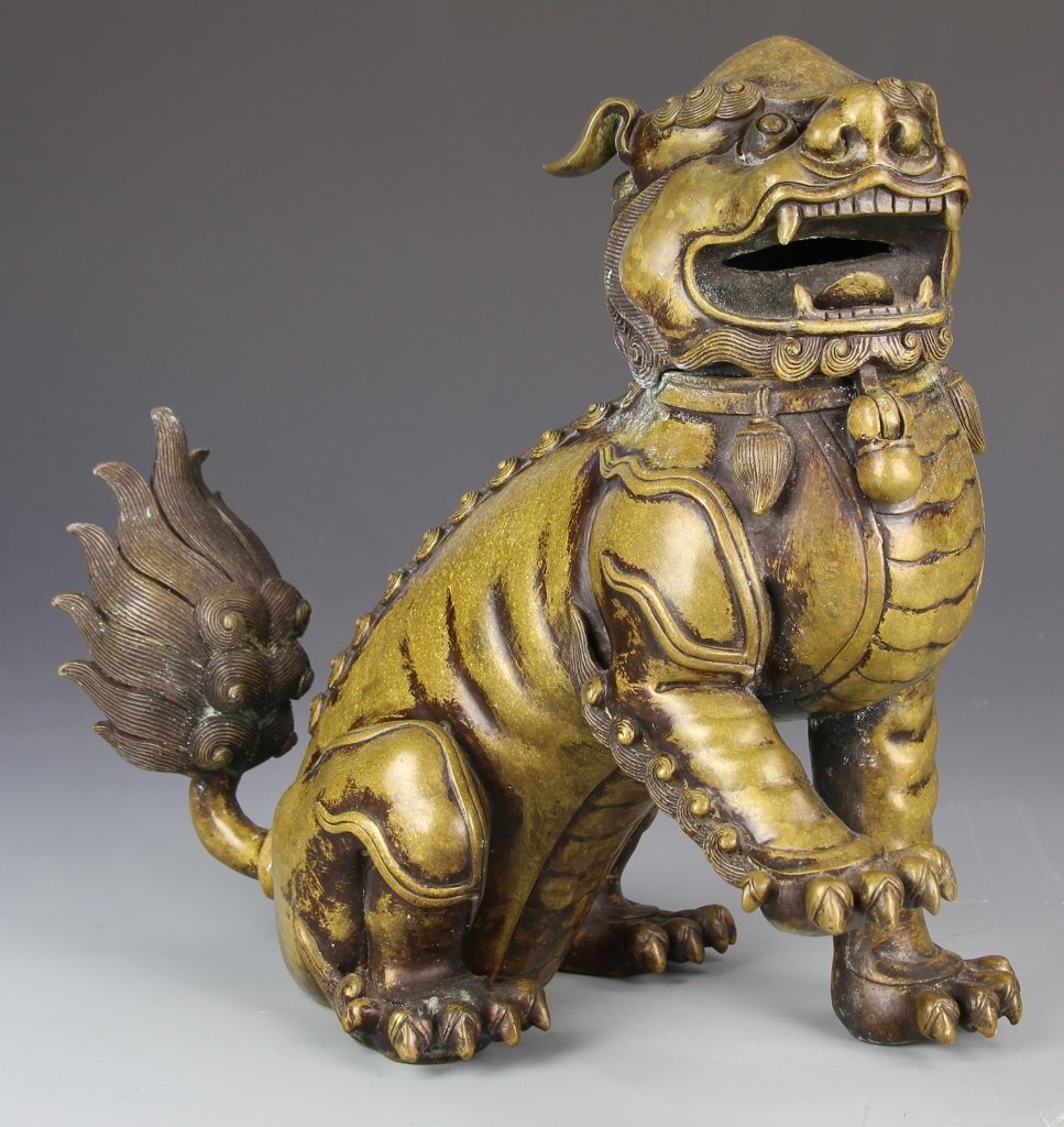 Chinese Foo Lion Censer: China, 18th C., foo lion censer, seated with right paw extended, highly detailed with individual lines incised on the beard, eyebrows and tail, painted gold. Height 10 1/2 in., Width 10 in.