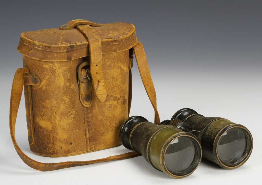 American Binoculars with Case: America, 19th C., binoculars with light tan leather case, the glasses a green/brown color, the case with a large strap and buckle enclosure, age is evident in both the leather bag and the binoculars.