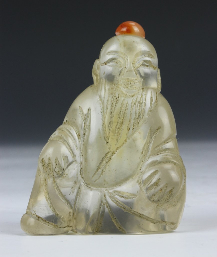 SOLD Chinese Crystal Snuff Bottle: China, carved crystal snuff bottle in the form of Shoulao, in a seated position with a detailed facial expression and robes, with stopper. Height 2 1/2 in.