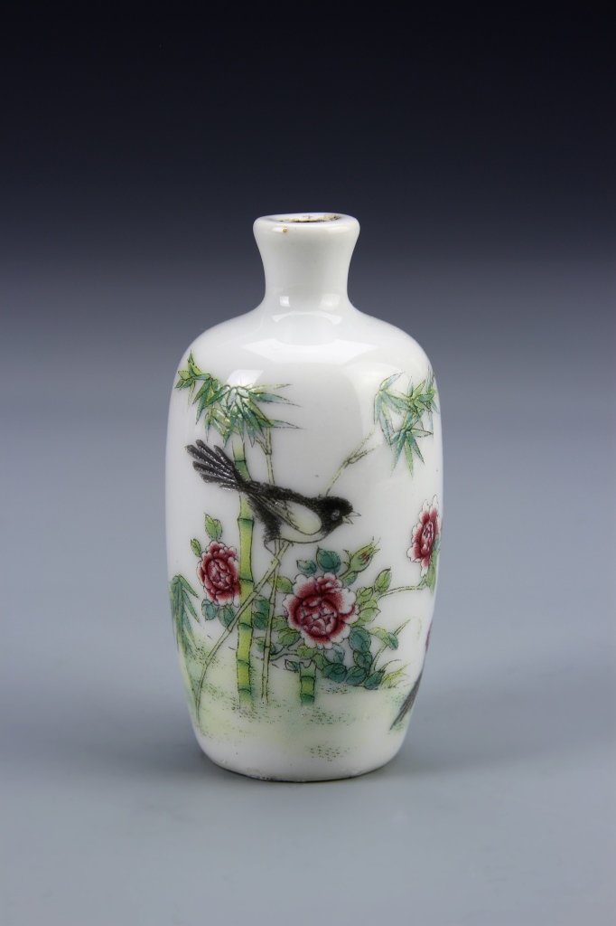 Chinese Famille Rose Snuff Bottle: China, Famille Rose snuff bottle, in cylindrical form, with tapered beck, white glaze, and colorful bird and flower motifs, mark on base. Height 3 in.