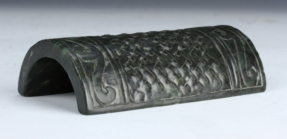 Chinese Antique Spinach Jade Wrest Rest: China, antique, spinach jade wrest rest, with carved geometric patterns banded on the top with organic shapes comprising the middle. Height 1 1/2 in. Length 5 in.