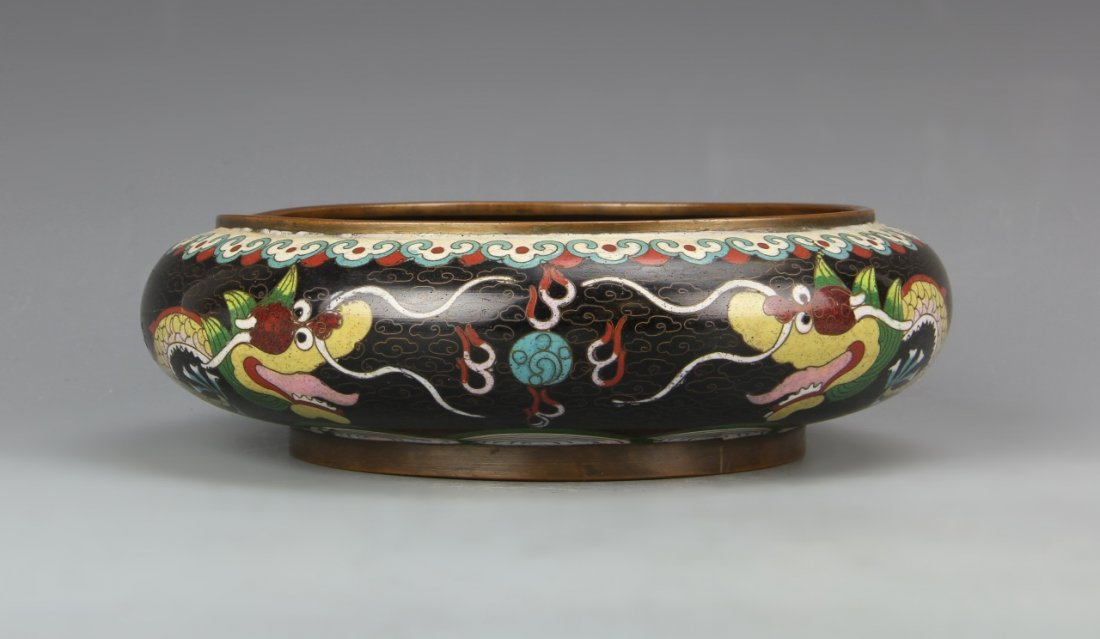 Chinese Cloisonne Brush Washer: China, ROC Period, cloisonne brush washer, slightly raised base, metal details on rim and base, back ground and dragons encircling body, on bent on rim. Diameter 8 in.